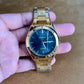 Moment Gold Stainless Steel Quartz Watch – Blue Dial, Date Display